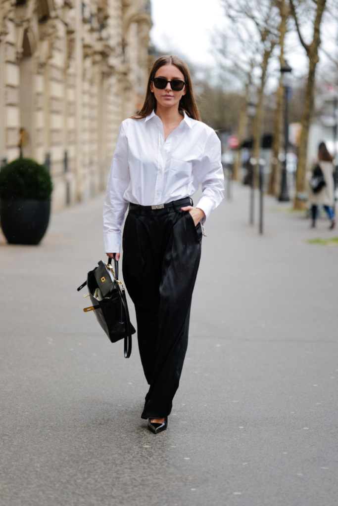 elegantne oblečená podnikateľka v bielej košeli s kufríkom
